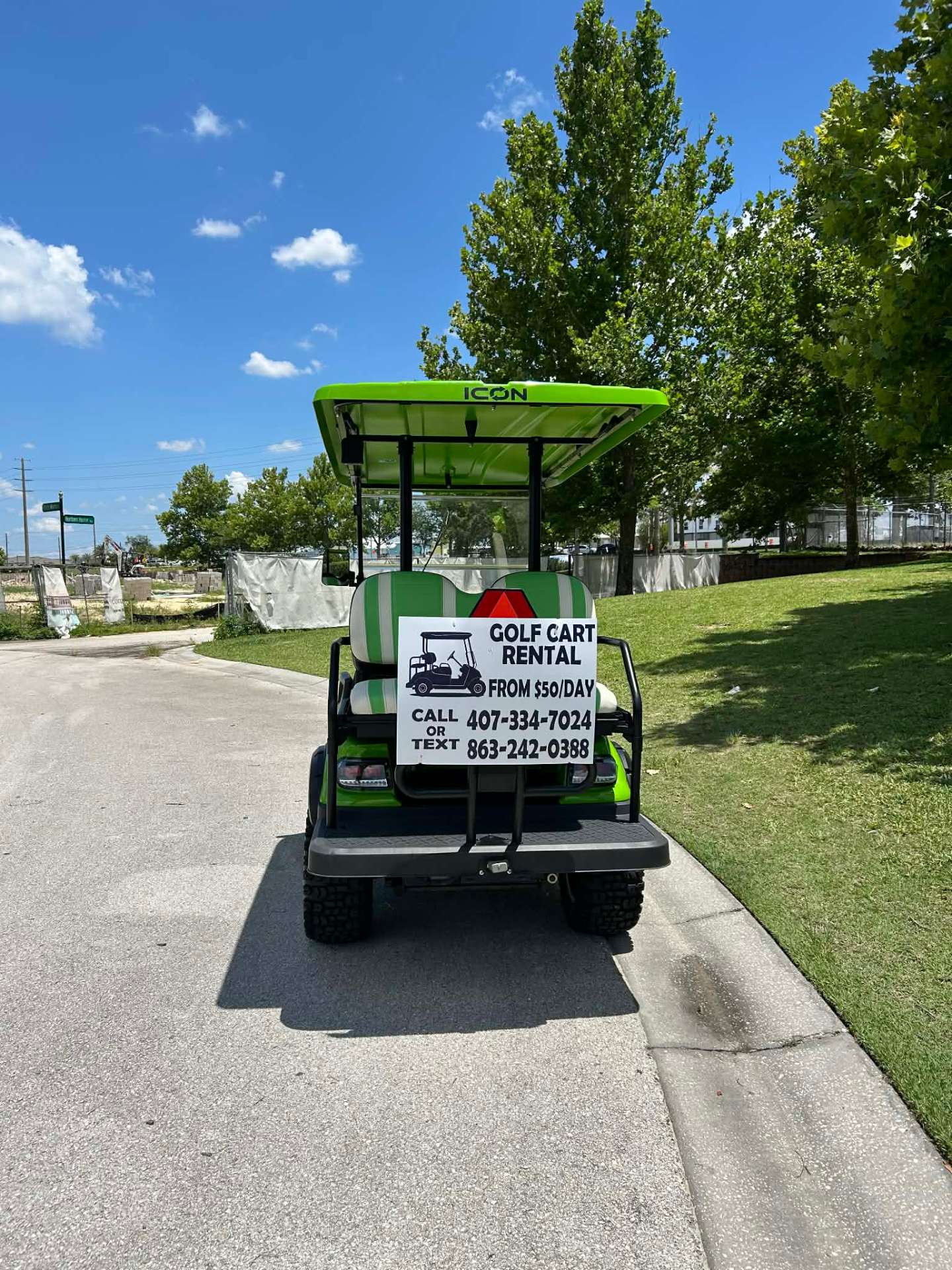Black luxury golf cart with call or text rental sign at sunset in Reunion Resort