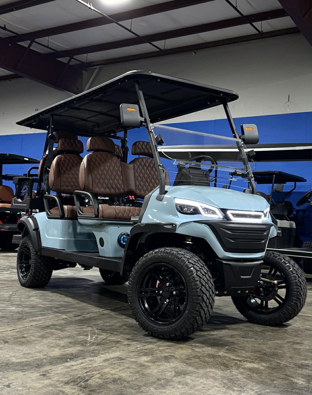 Teal Verdi 6-passenger luxury golf cart on the showroom floor